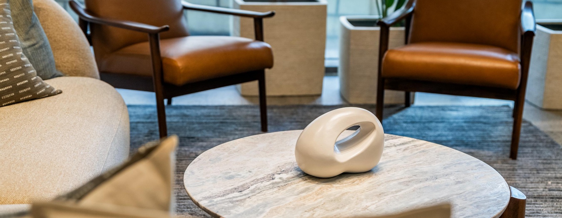 Coffee table with white porcelain decor surrounded by chairs