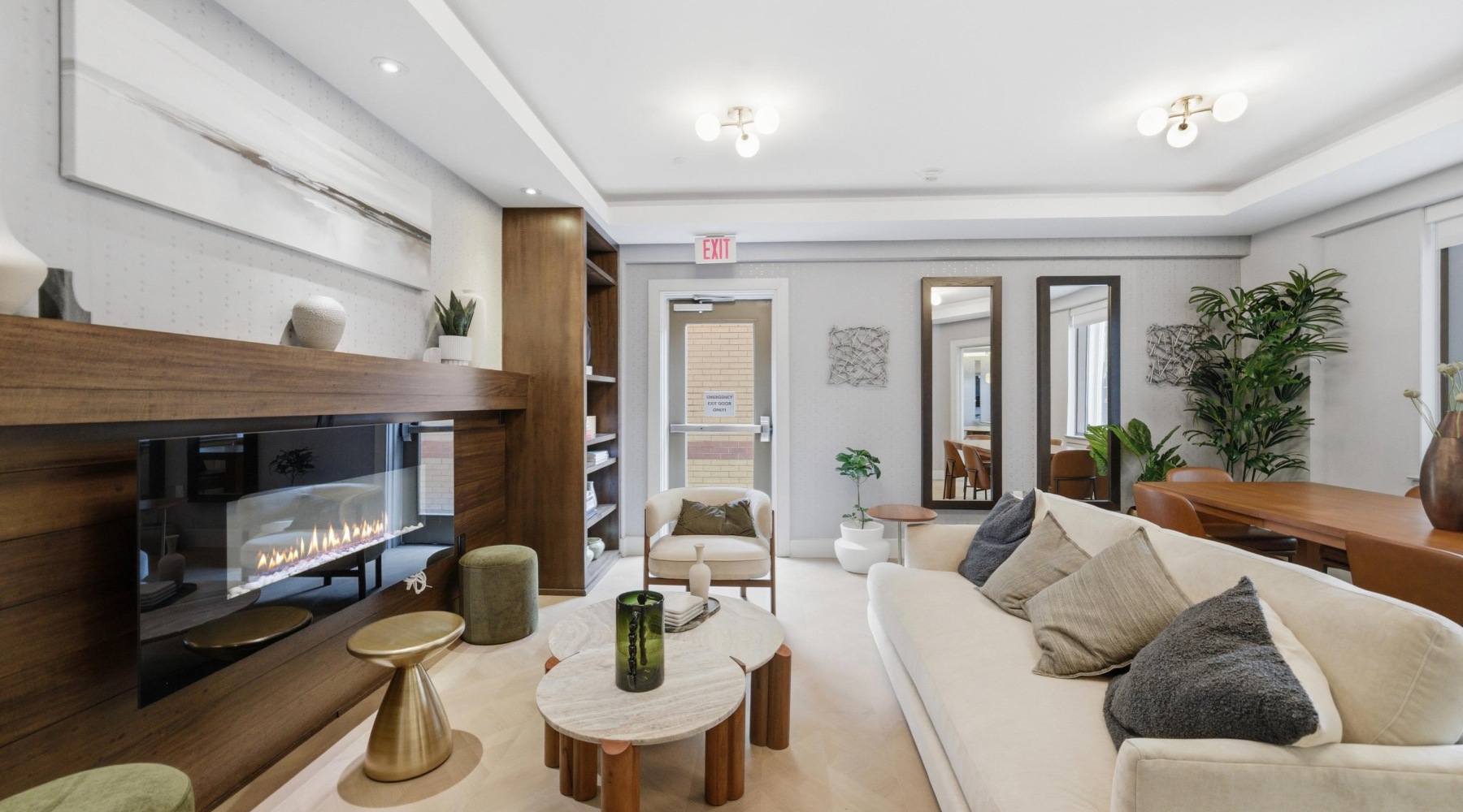 A modern room showing sofa, various seating, fireplace, and more