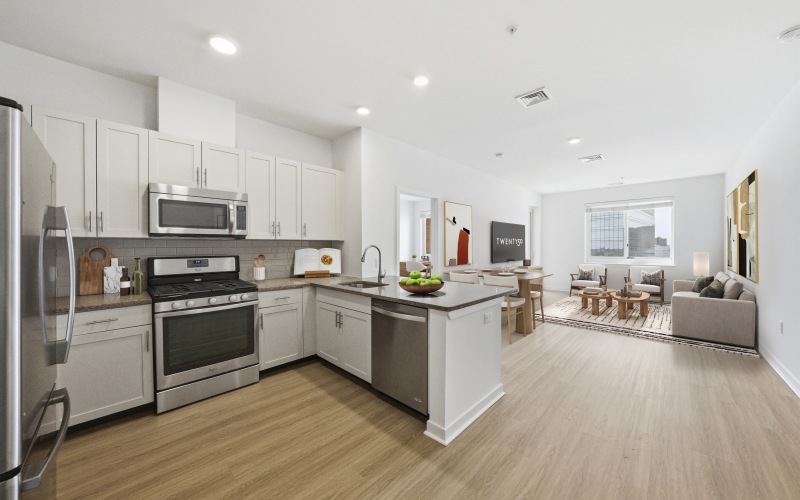 Kitchen with light cabinets showing into living room